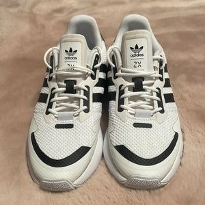 Adidas sneakers. White with black strips and black back.